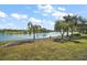 Beautiful backyard view overlooking the lake with lush landscaping and seating area in a tranquil setting at 8920 Bridgeport Bay Cir, Mount Dora, FL 32757
