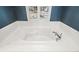Close-up of a large soaking tub under a window, perfect for relaxing after a long day at 8920 Bridgeport Bay Cir, Mount Dora, FL 32757