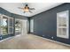 Bedroom featuring large windows with shutters and sliding doors leading to a patio with water view at 8920 Bridgeport Bay Cir, Mount Dora, FL 32757
