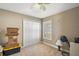 Neutral bedroom featuring a window with plantation shutters, closet, and ceiling fan offering a serene atmosphere at 8920 Bridgeport Bay Cir, Mount Dora, FL 32757