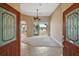 Welcoming foyer showcasing tile flooring and a view of the living area with access to a serene outdoor space at 8920 Bridgeport Bay Cir, Mount Dora, FL 32757