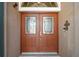 Close-up view of the front doors, featuring decorative glass panels that add elegance and curb appeal at 8920 Bridgeport Bay Cir, Mount Dora, FL 32757