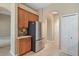 Kitchen includes stainless steel refrigerator, wood cabinets, and white pantry door at 8920 Bridgeport Bay Cir, Mount Dora, FL 32757