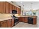 Well-lit kitchen features stainless steel appliances, light countertops, and a view to the water at 8920 Bridgeport Bay Cir, Mount Dora, FL 32757