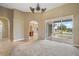 Bright living area offering access to the screened patio and a glimpse of the lake, enhancing its appeal at 8920 Bridgeport Bay Cir, Mount Dora, FL 32757