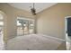 Bright living room with sliding glass doors leading to an outdoor patio and a serene water view at 8920 Bridgeport Bay Cir, Mount Dora, FL 32757
