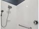 Modern shower featuring tiled walls, updated fixtures, and a built-in grab bar for added safety at 8920 Bridgeport Bay Cir, Mount Dora, FL 32757