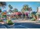 Street view with palm trees showcasing vibrant local businesses and eateries at 8920 Bridgeport Bay Cir, Mount Dora, FL 32757