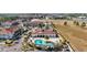 Community pool and clubhouse with surrounding buildings and parking at 8988 Silver Pl, Kissimmee, FL 34747