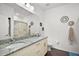 Double vanity bathroom with granite countertop and shower at 8988 Silver Pl, Kissimmee, FL 34747