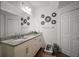 Bathroom with double vanity, granite countertop, and decorative mirrors at 8988 Silver Pl, Kissimmee, FL 34747