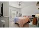 Bright bedroom with a queen bed, window, and built-in shelving at 8988 Silver Pl, Kissimmee, FL 34747