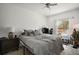 Bedroom with gray bedding, ceiling fan, and large window at 8988 Silver Pl, Kissimmee, FL 34747