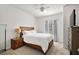 Bedroom with wood bed frame, nightstand, and window at 8988 Silver Pl, Kissimmee, FL 34747