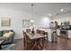 Open concept dining room with wooden table and kitchen views at 8988 Silver Pl, Kissimmee, FL 34747