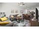 Open concept living room with gray couch, wood coffee table, and kitchen at 8988 Silver Pl, Kissimmee, FL 34747