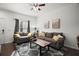 Living room features gray couch, yellow pillows, and wood floor at 8988 Silver Pl, Kissimmee, FL 34747