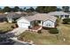 Single-story house with a two-car garage and well-maintained lawn at 9401 Se 132Nd Loop, Summerfield, FL 34491