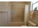 Bathroom with shower/tub combo and linen storage at 9401 Se 132Nd Loop, Summerfield, FL 34491