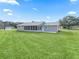 Spacious backyard with large grassy area and screened porch at 9897 Se 178Th Pl, Summerfield, FL 34491