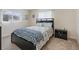 Cozy bedroom with bed, nightstand and window at 9897 Se 178Th Pl, Summerfield, FL 34491