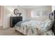 Bedroom with a dresser and comfortable bed at 9897 Se 178Th Pl, Summerfield, FL 34491