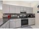 Kitchen with modern cabinetry and stove at 9897 Se 178Th Pl, Summerfield, FL 34491