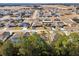 Aerial view of a suburban neighborhood with houses, trees, and open areas at 10291 Se 69Th Ter, Belleview, FL 34420