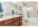 Clean bathroom with wood cabinets, a bathtub, and a shower at 10291 Se 69Th Ter, Belleview, FL 34420