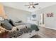 Primary bedroom with white bed frame, dresser and TV at 10291 Se 69Th Ter, Belleview, FL 34420