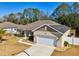 One story home with solar panels, two-car garage and palm tree at 10291 Se 69Th Ter, Belleview, FL 34420