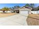 Front view of a house with a long driveway at 10291 Se 69Th Ter, Belleview, FL 34420