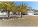 House exterior showcasing landscaping with palm trees at 10291 Se 69Th Ter, Belleview, FL 34420