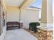 Covered porch with a bench and stone columns at 10291 Se 69Th Ter, Belleview, FL 34420