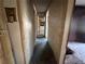 Hallway with worn tile flooring at 1109 Pioneer Trl, Leesburg, FL 34748