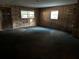 Living room with worn carpet and wood paneling at 1109 Pioneer Trl, Leesburg, FL 34748