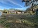 Overgrown lot with house in the background at 1109 Pioneer Trl, Leesburg, FL 34748