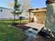 Covered patio with seating and view of the backyard at 114 Chestnut St, Leesburg, FL 34748