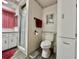 Well-lit bathroom with tiled shower, toilet, and vanity with cabinets at 114 Chestnut St, Leesburg, FL 34748