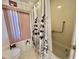 Bathroom featuring floral shower curtain, pink window blinds, and toilet at 114 Chestnut St, Leesburg, FL 34748