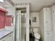 Well-lit bathroom featuring tiled shower, toilet, and vanity at 114 Chestnut St, Leesburg, FL 34748
