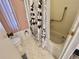 Bathroom featuring floral shower curtain, pink window blinds, and toilet at 114 Chestnut St, Leesburg, FL 34748