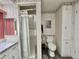 Bathroom with shower, marbled vanity, toilet, and storage cabinet at 114 Chestnut St, Leesburg, FL 34748