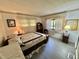 Comfortable bedroom featuring light walls, wood-look floors, and natural light at 114 Chestnut St, Leesburg, FL 34748
