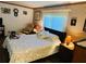 Bedroom with dresser and rocking chair, featuring wood floors at 114 Chestnut St, Leesburg, FL 34748