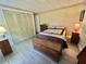 Charming bedroom with a decorative bed, closet, and storage chest at 114 Chestnut St, Leesburg, FL 34748