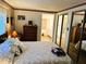 Main bedroom with mirrored closet doors and ensuite bathroom at 114 Chestnut St, Leesburg, FL 34748