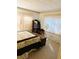 Cozy bedroom featuring a wooden dresser and window coverings at 114 Chestnut St, Leesburg, FL 34748