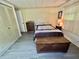 Bedroom featuring a closet, dresser, decorative bed, and storage chest at 114 Chestnut St, Leesburg, FL 34748