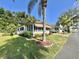 Charming single-story home with well-manicured lawn, mature palms and meticulous landscaping at 114 Chestnut St, Leesburg, FL 34748